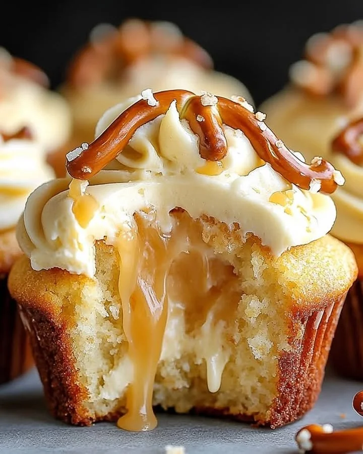 Gooey salted caramel cream cheese cupcakes topped with caramel drizzle