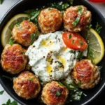 Plate of Greek chicken meatballs served with tzatziki sauce.