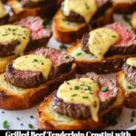 Grilled beef tenderloin crostini garnished with Béarnaise sauce