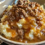 Ground beef and gravy served over fluffy mashed potatoes