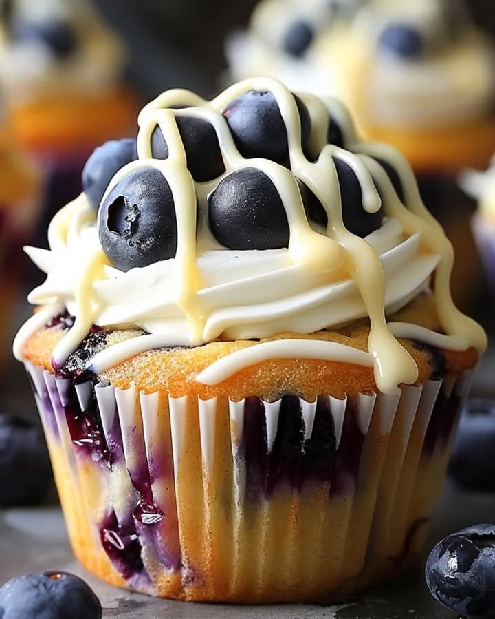 Heavenly White Chocolate Blueberry Cheesecake Cupcakes topped with blueberries