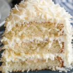 Heavenly white chocolate coconut cake decorated with coconut flakes and chocolate shavings.
