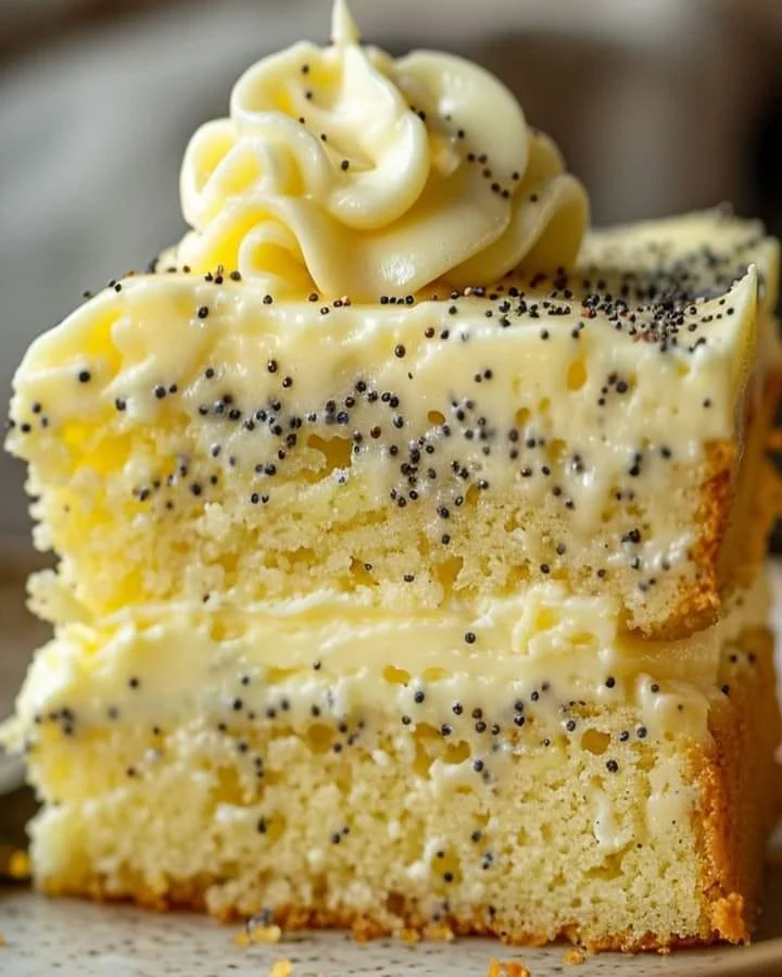 Slice of homemade lemon poppy seed pudding cake with a drizzle of lemon glaze