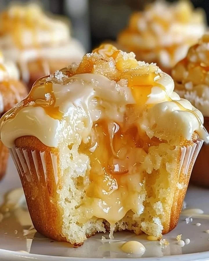 Honey peach cream cheese cupcakes topped with fresh peach slices.
