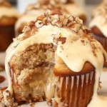Banana cinnamon pecan cupcakes topped with frosting and pecans