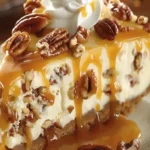 Slice of Pecan Caramel Cheesecake topped with caramel drizzle and pecans