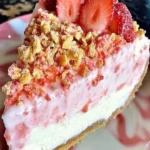 Irresistible Strawberry Crunch Cheesecake topped with fresh strawberries and a crunchy crust.