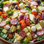 A colorful bowl of Italian Chopped Salad with fresh vegetables and dressing