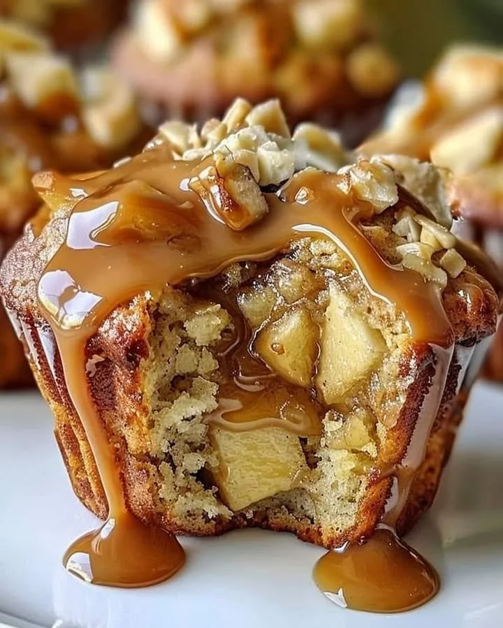 Delicious caramel apple muffins topped with caramel drizzle and apple chunks