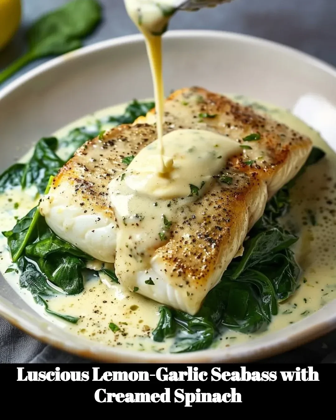 Lemon-garlic seabass fillet on a plate with creamed spinach
