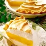 Delicious slice of magic lemon pie with a golden crust and vibrant lemon filling