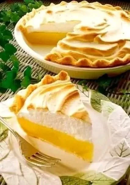 Delicious slice of magic lemon pie with a golden crust and vibrant lemon filling