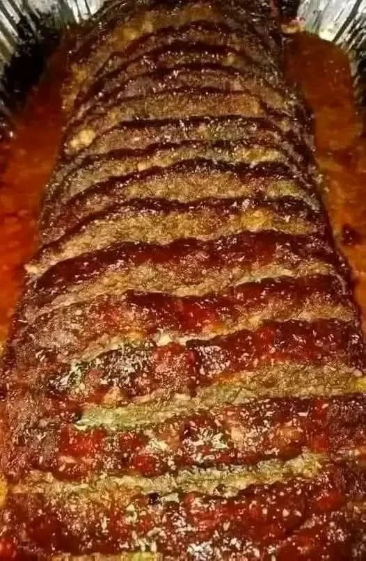 Delicious homemade meatloaf served on a plate with garnished vegetables