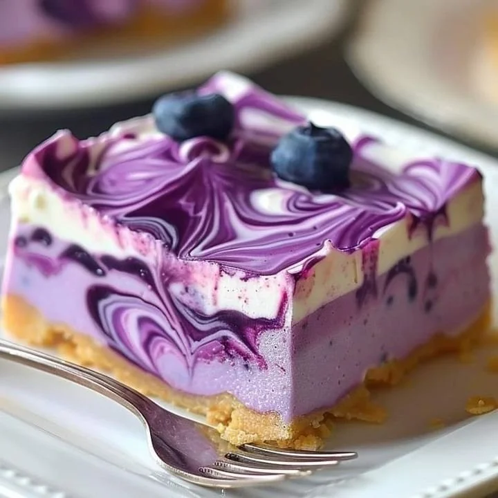 Delicious no bake blueberry dessert topped with fresh blueberries and whipped cream