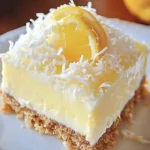 No bake lemon coconut cheesecake bars with a zesty topping on a white plate