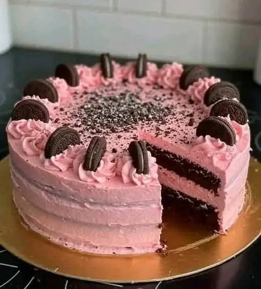 Delicious Pink Oreo Cake decorated with cream and Oreo crumbs