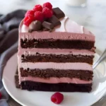 Delicious Raspberry Chocolate Mousse Cake with fresh berries and chocolate ganache