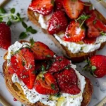 Delicious roasted strawberry whipped ricotta toast topped with fresh strawberries.