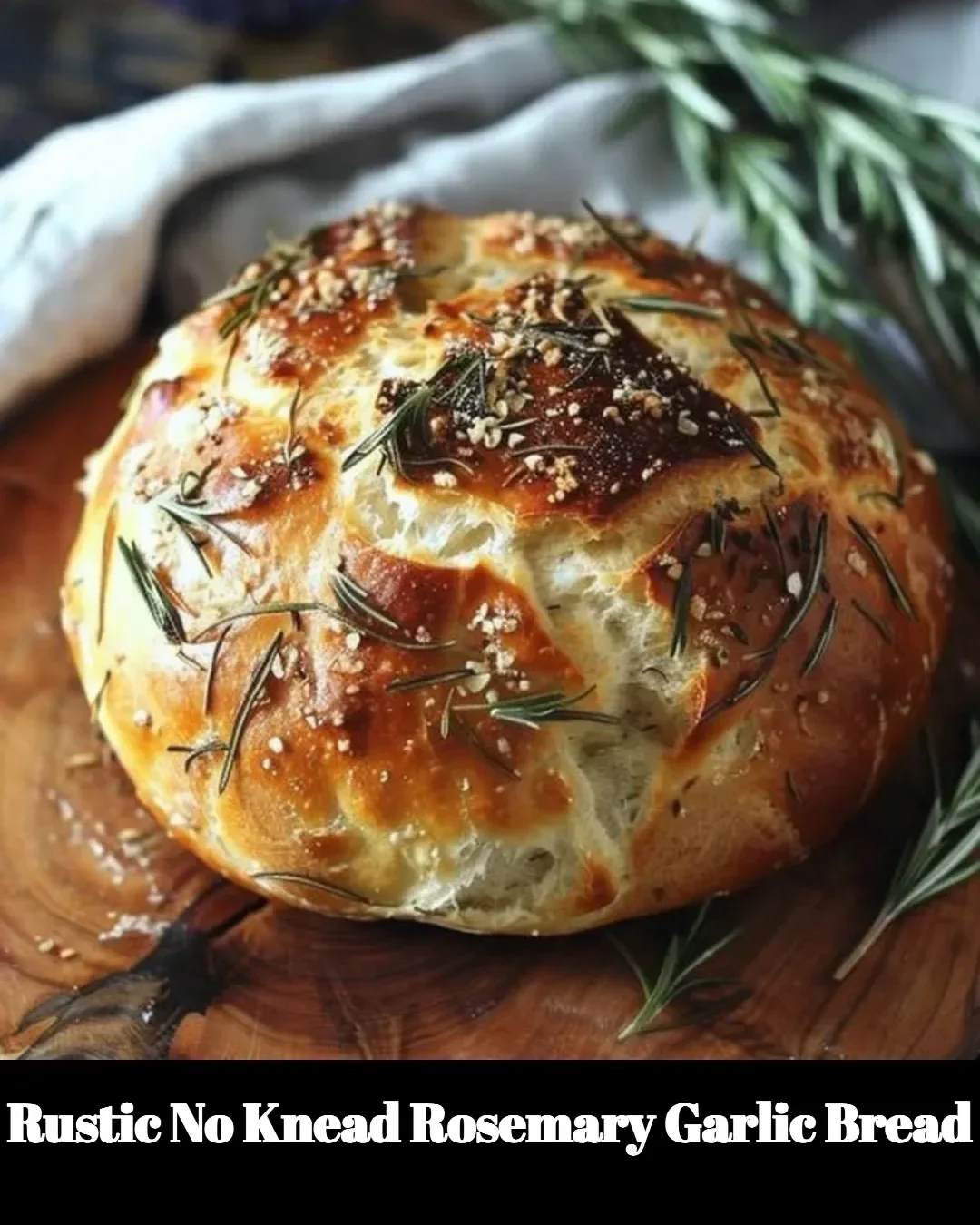 Freshly baked rustic no knead rosemary garlic bread on a wooden table