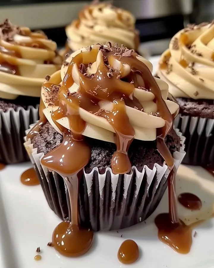Delicious Salted Caramel Chocolate Cupcakes topped with salted caramel drizzle and sprinkles.