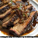 Slow cooker brisket with balsamic onion gravy served on a plate