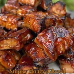 Smoky honey-glazed pork rib tips cooked to perfection on a grill