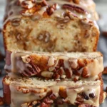 Slice of Southern Pecan Praline Buttermilk Cake topped with pecans and praline glaze