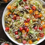 Colorful Spaghetti Salad with vegetables and dressing in a bowl