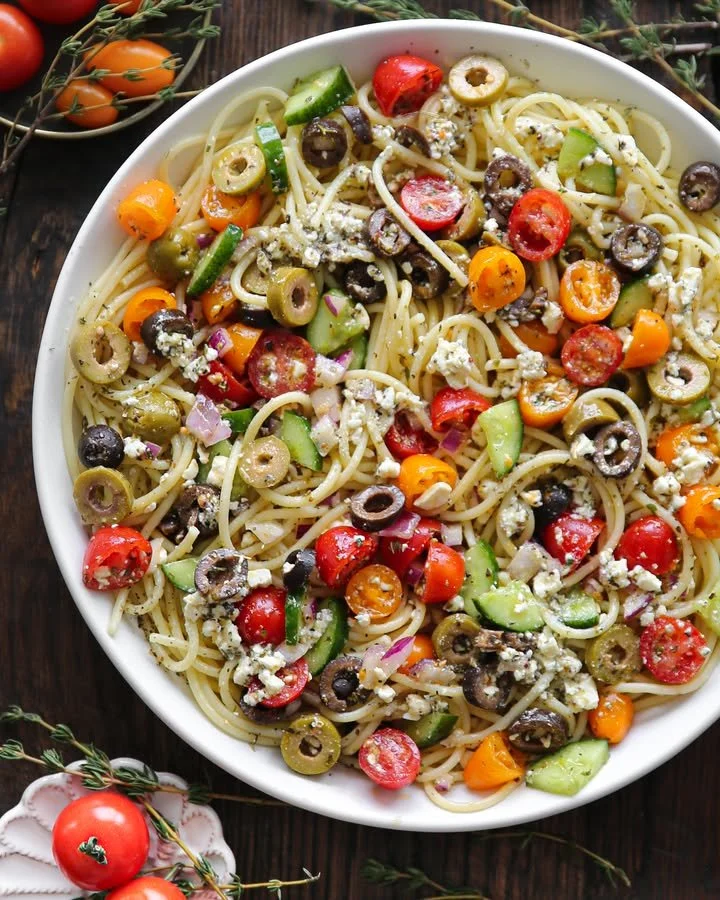 Colorful Spaghetti Salad with vegetables and dressing in a bowl