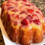 Slice of strawberry vanilla pound cake with fresh strawberries on top