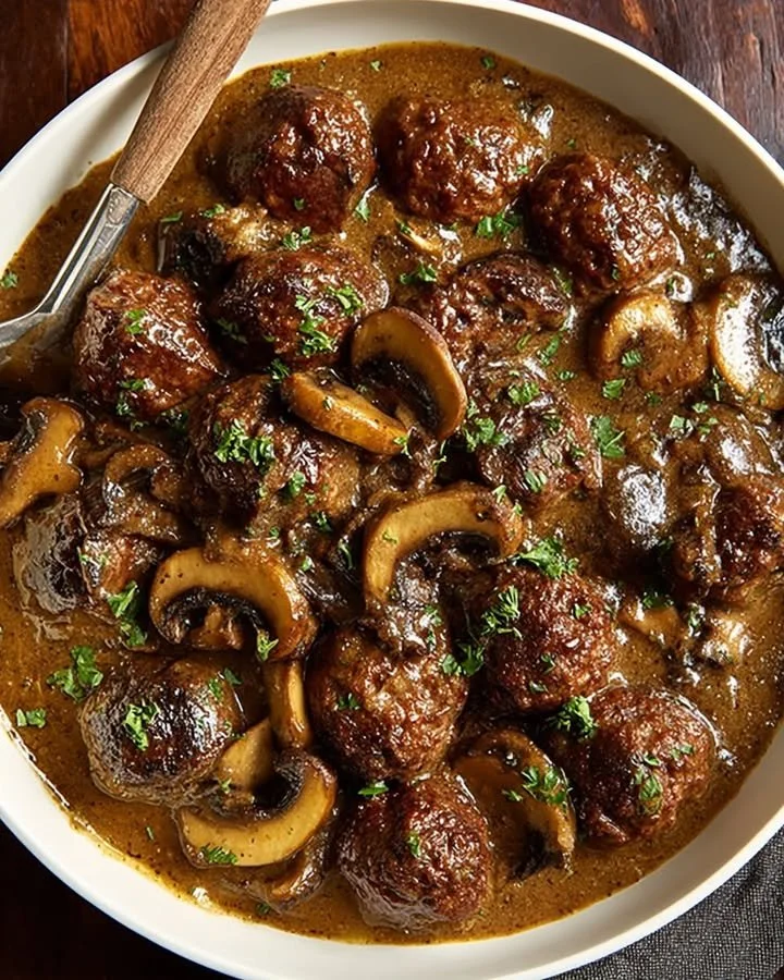 Delicious Salisbury steak meatballs topped with rich mushroom gravy on a plate
