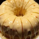 Vanilla Buttermilk Pound Cake topped with cream cheese glaze on a rustic plate