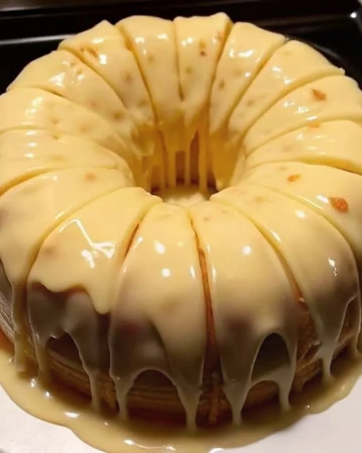 Vanilla Buttermilk Pound Cake topped with cream cheese glaze on a rustic plate