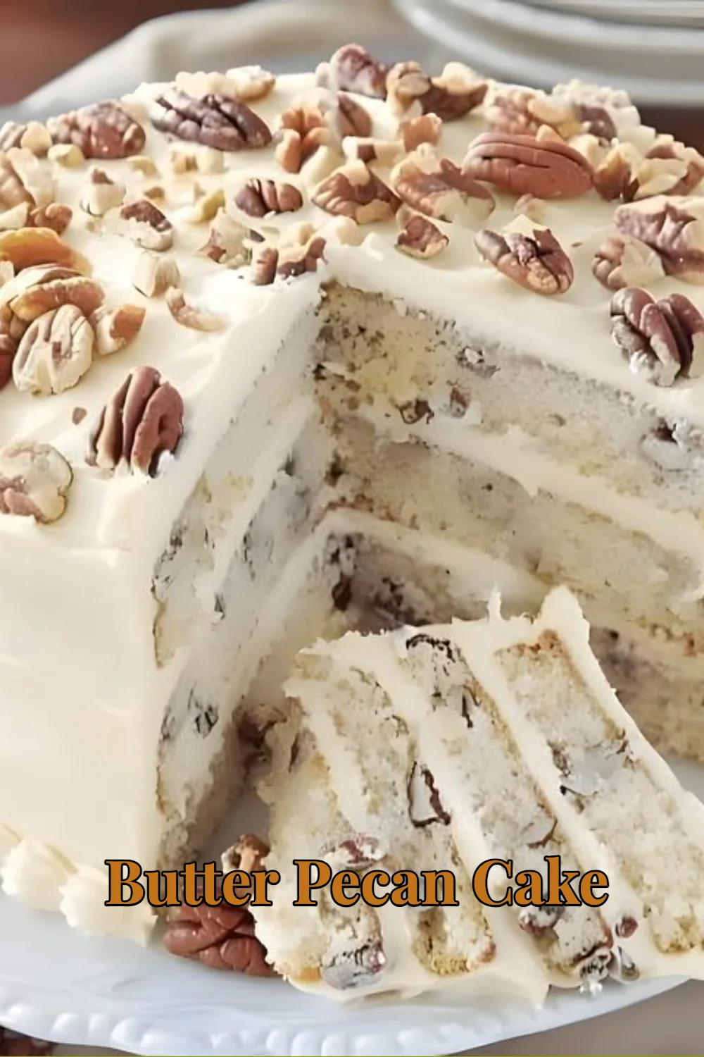 Delicious Butter Pecan Cake topped with nuts and creamy frosting