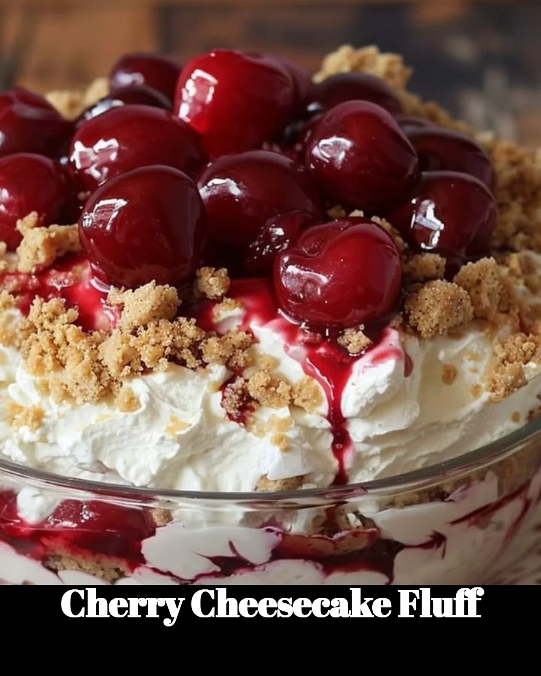 Delicious Cherry Cheesecake Fluff dessert served in a bowl with fresh cherries on top.