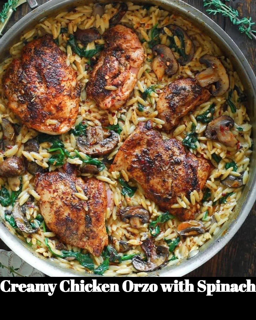 Creamy chicken orzo with spinach in a bowl garnished with herbs.