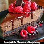Delicious slice of Chocolate Raspberry Cheesecake with chocolate shavings and fresh raspberries