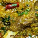 Delicious Muslim style mutton stew garnished with fresh herbs and spices.