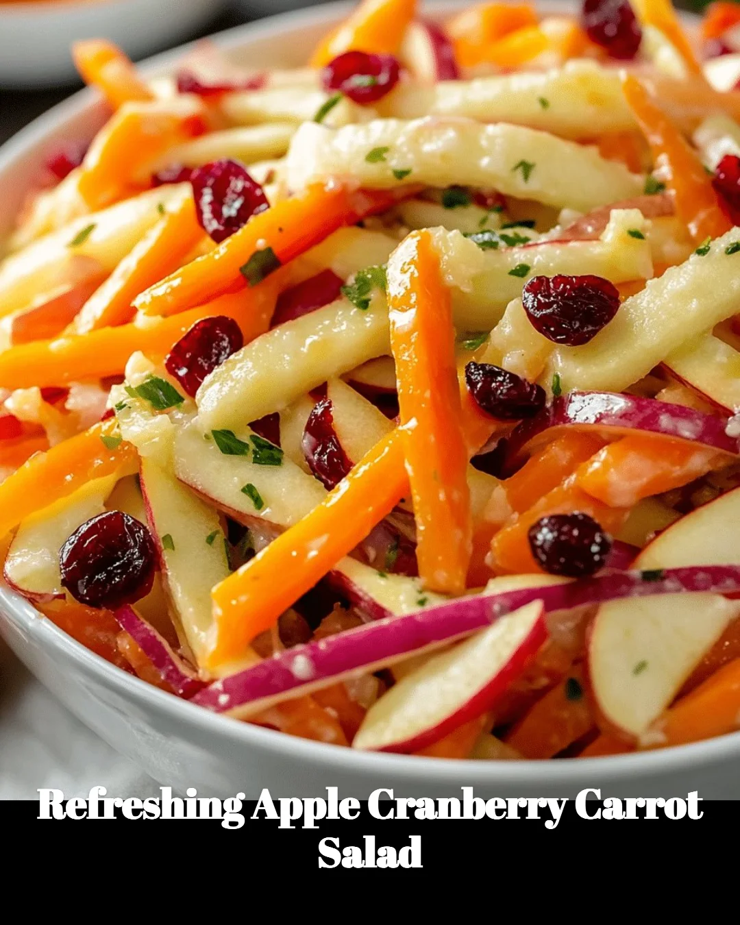 A vibrant apple cranberry carrot salad served in a bowl, showcasing fresh ingredients.