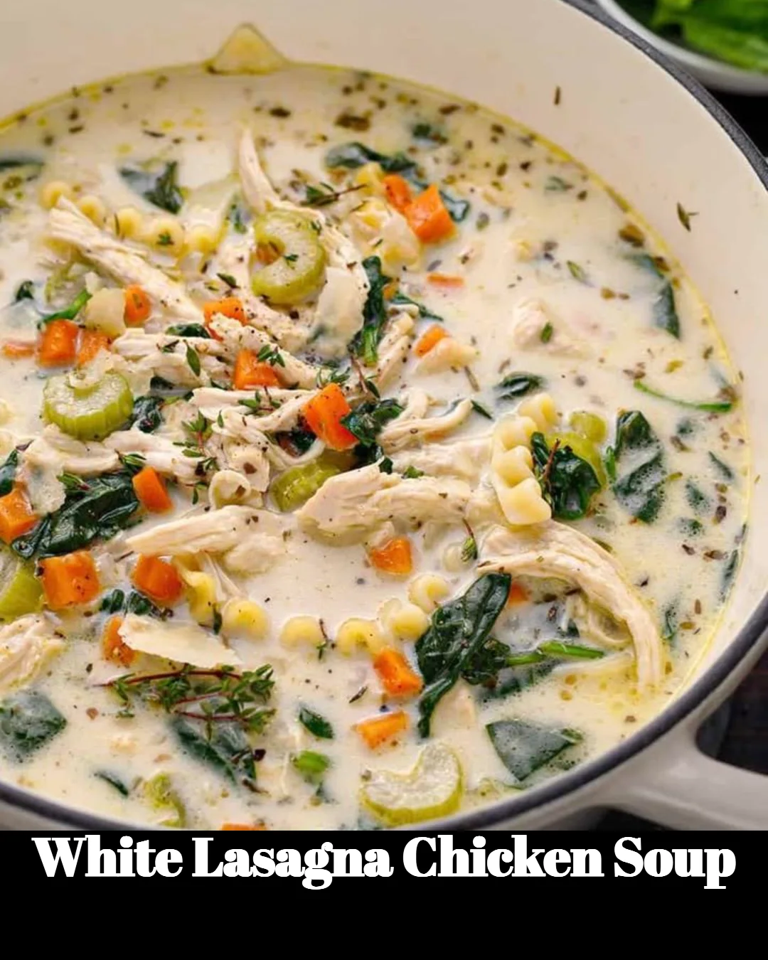 Bowl of White Lasagna Chicken Soup topped with fresh herbs and cheese