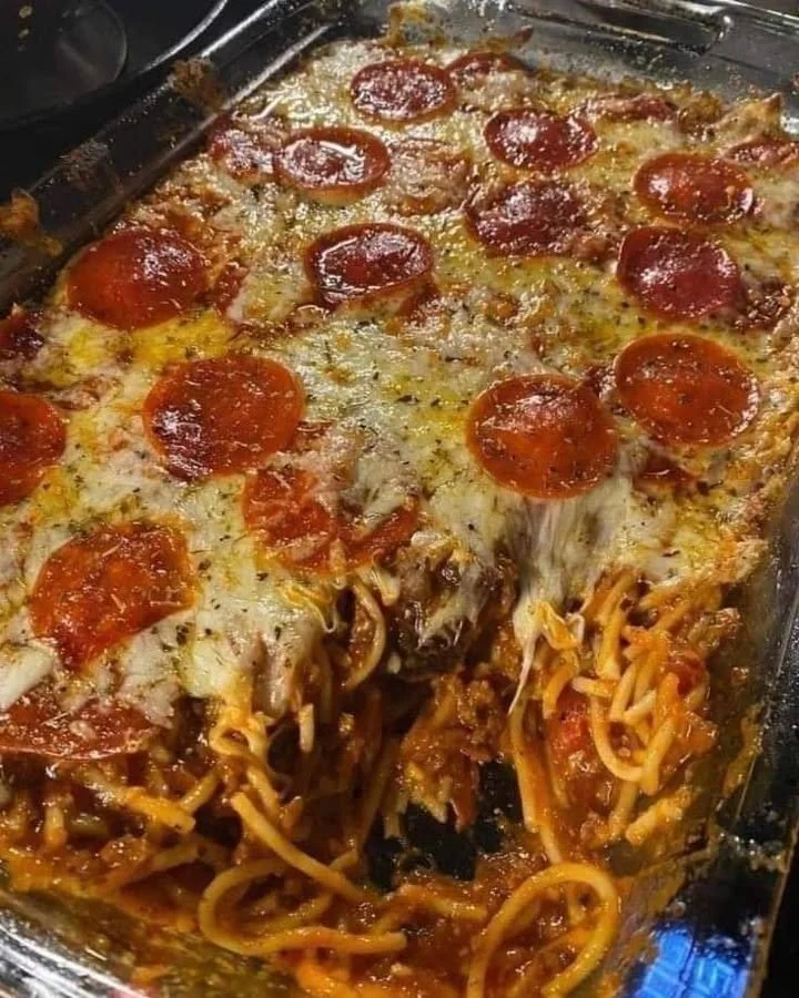 Delicious baked pizza spaghetti dish topped with melted cheese and pepperoni