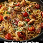 Delicious Bruschetta Chicken Pasta topped with fresh tomatoes and basil.