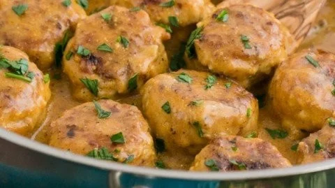 Delicious chicken meatballs in creamy sauce served on a plate