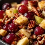 A bowl of Cinnamon Apple Grape Salad with fresh apples, grapes, and cinnamon.