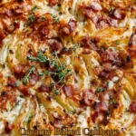 Creamy baked cabbage topped with crispy bacon on a plate