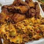 Crispy fried chicken wings served with cheesy lasagna on a plate