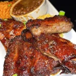 Crockpot barbecue ribs served on a plate with a side of coleslaw