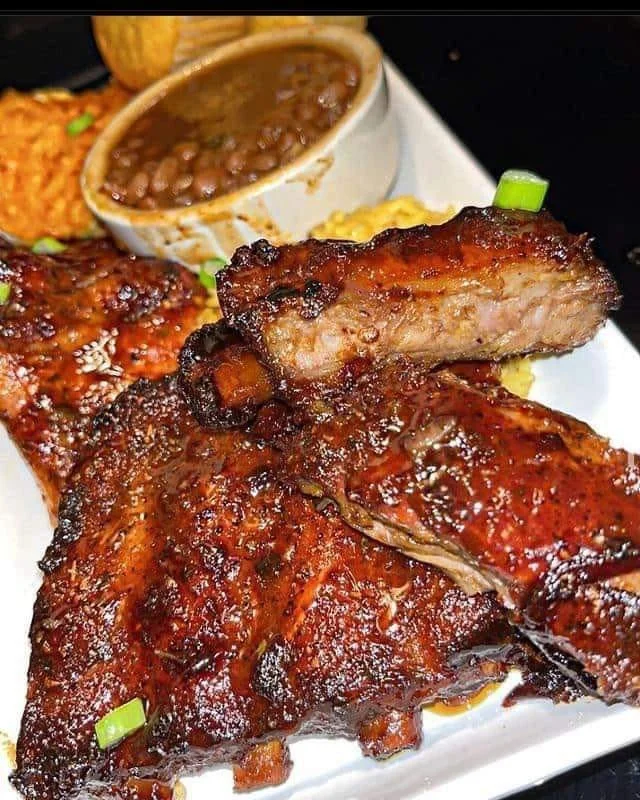 Crockpot barbecue ribs served on a plate with a side of coleslaw