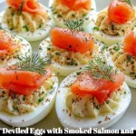 Deviled eggs topped with smoked salmon and dill on a serving platter