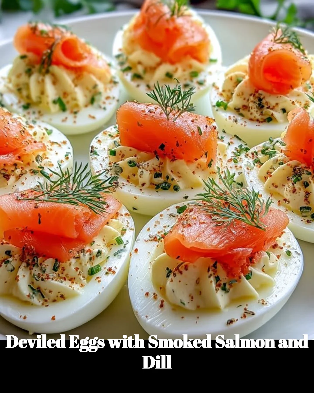 Deviled eggs topped with smoked salmon and dill on a serving platter